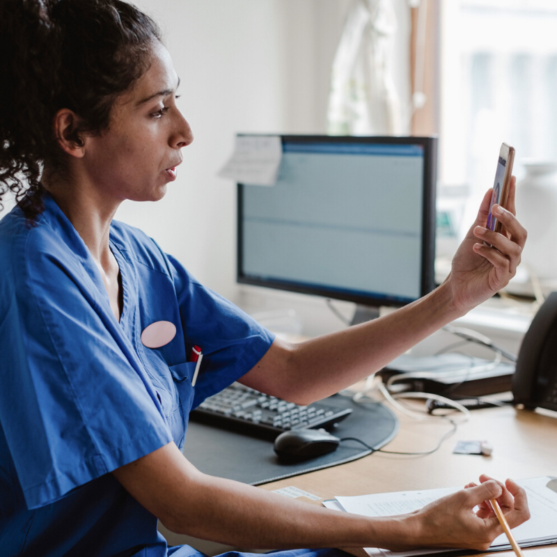 Medical professional holding a consultation over a mobile phone